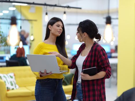 group of female friends having a team meeting and discussion about project or in modern startup business open space coworking office