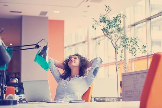 happy young  business woman with curly hairstyle in the modern office