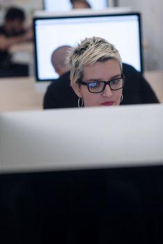 startup business, woman  working on dektop  computer at creative modern office relaxing and have fun