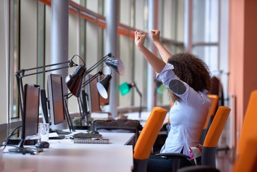 happy young  business woman with curly hairstyle in the modern office