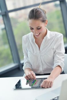 portrait of Young pretty business woman work on  notebook computer  in the bright modern office indoors