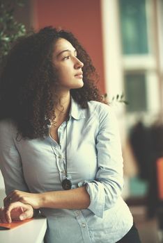 happy young  business woman with curly hairstyle in the modern office