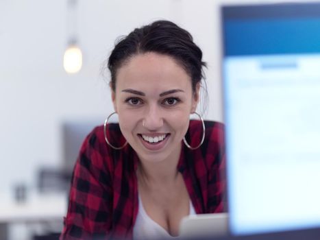 business woman portrait in open space startup coworking office as influencer using smart phone, tablet computer