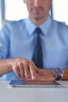 close-up of human hand  business man using tablet compuer at office