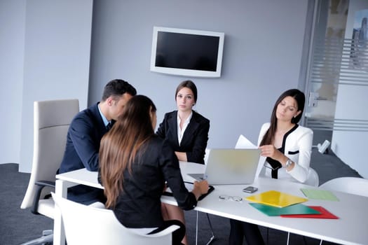 Group of happy young  business people in a meeting at office