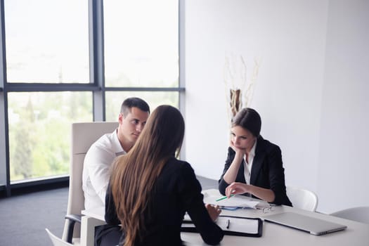 Group of happy young  business people in a meeting at office