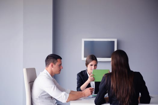 Group of happy young  business people in a meeting at office