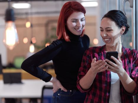 group of female friends having a team meeting and discussion about project in modern startup business open space coworking office