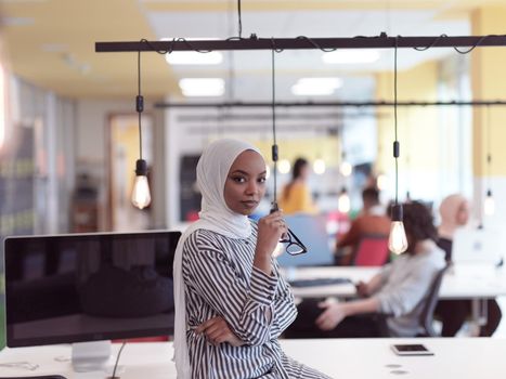 african americam modern muslim businesswoman portrait  wearing hijab at creative modern startup coworking open space office