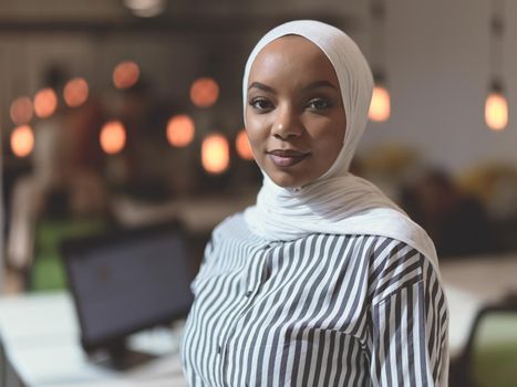 african muslim businesswoman portrait  wearing hijab at creative modern startup coworking open space office