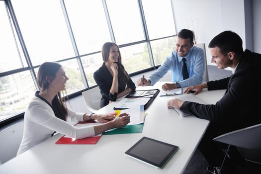 Group of happy young  business people in a meeting at office