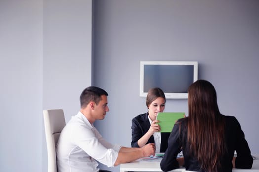 Group of happy young  business people in a meeting at office