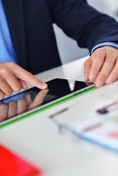 close-up of human hand  business man using tablet compuer at office