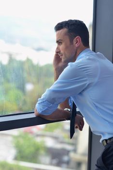 business man talking by cellphone in office