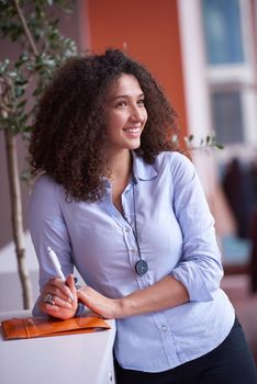 happy young  business woman with curly hairstyle in the modern office