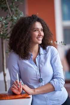 happy young  business woman with curly hairstyle in the modern office