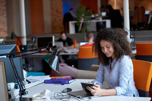 happy young  business woman with curly hairstyle in the modern office