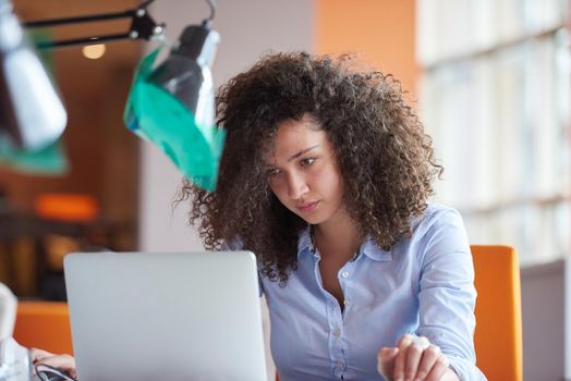 happy young  business woman with curly hairstyle in the modern office