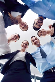 business people group joining hands and representing concept of friendship and teamwork,  low angle view