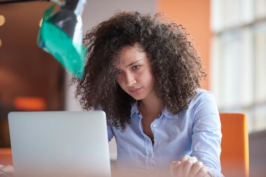 happy young  business woman with curly hairstyle in the modern office