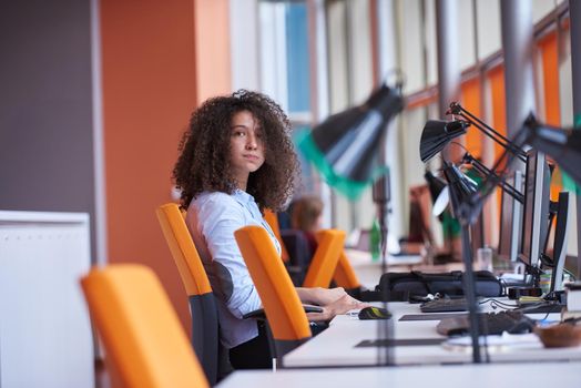 happy young  business woman with curly hairstyle in the modern office