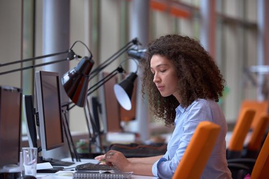 happy young  business woman with curly hairstyle in the modern office