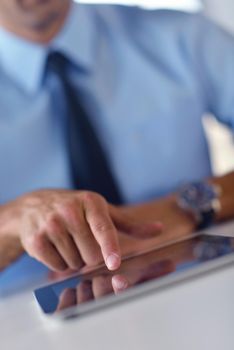 close-up of human hand  business man using tablet compuer at office