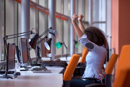 happy young  business woman with curly hairstyle in the modern office