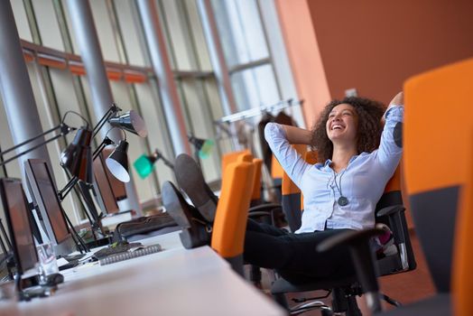 happy young  business woman with curly hairstyle in the modern office