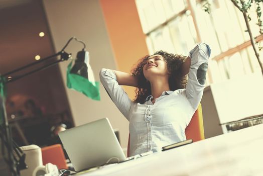 happy young  business woman with curly hairstyle in the modern office