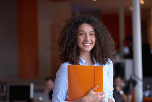 happy young  business woman with curly hairstyle in the modern office