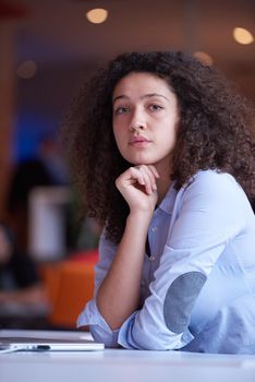 happy young  business woman with curly hairstyle in the modern office