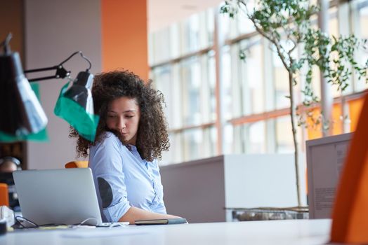 happy young  business woman with curly hairstyle in the modern office