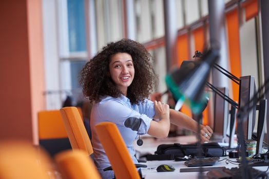 happy young  business woman with curly hairstyle in the modern office