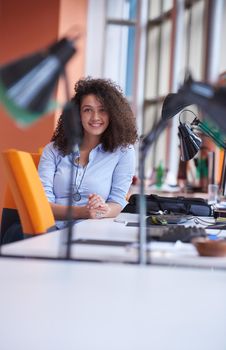 happy young  business woman with curly hairstyle in the modern office