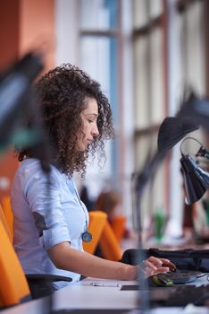 happy young  business woman with curly hairstyle in the modern office