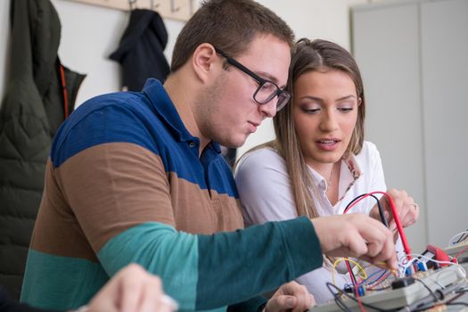 Group of young students doing technical vocational practice with teacher in the electronic classroom, Education and technology concept