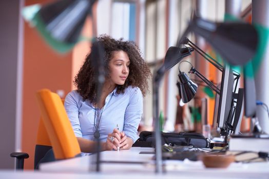 happy young  business woman with curly hairstyle in the modern office