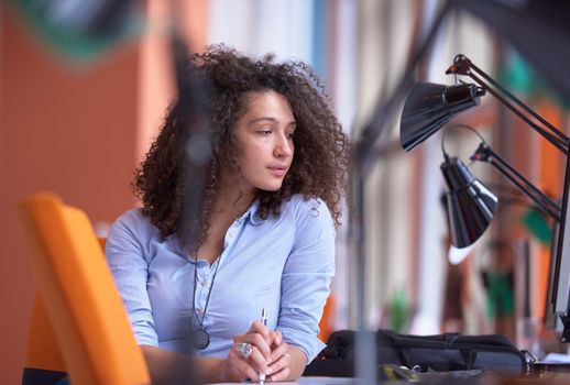 happy young  business woman with curly hairstyle in the modern office