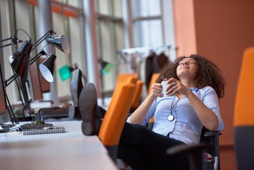 happy young  business woman with curly hairstyle in the modern office