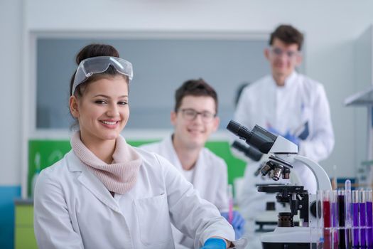 Group of young medical students doing research together in chemistry laboratory,teamwork by college student indoors