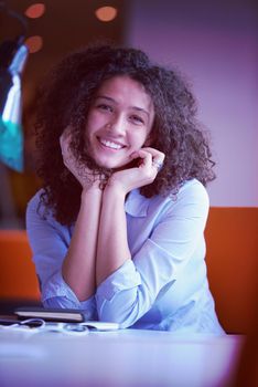 happy young  business woman with curly hairstyle in the modern office