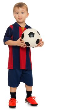 Portrait of a cheerful little boy football player in a striped uniform. The boy holds a hand soccer ball. Portrait in full growth - Isolated on white background