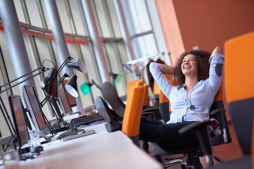 happy young  business woman with curly hairstyle in the modern office