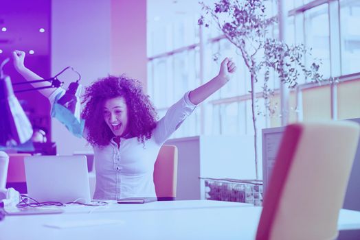 happy young  business woman with curly hairstyle in the modern office