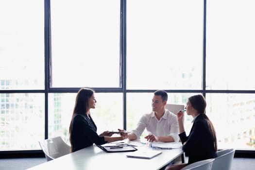 Group of happy young  business people in a meeting at office