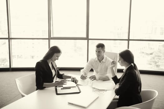 Group of happy young  business people in a meeting at office