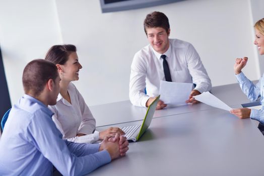 Group of happy young  business people in a meeting at office