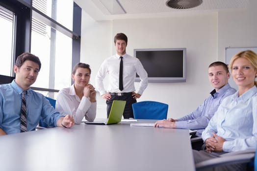 Group of happy young  business people in a meeting at office