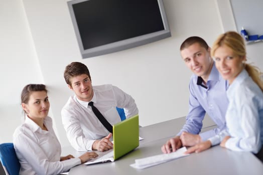 Group of happy young  business people in a meeting at office